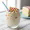 A tall, creamy blender-made drink showcasing classic Birthday Cake Protein Shake Ingredients, topped with sprinkles and granola, perfect for fans of Birthday Cake Protein Shake Recipes, indulgent Cake Batter Protein Shake Recipes, and a thick, dreamy Cake Batter Protein Shake served cold.