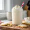 Thick and creamy Cookie Creamy Whip Protein Shake in a glass topped with whipped cream and sprinkles, styled as a festive Protein Shake With Cookies and indulgent Cookie Protein Shake that tastes like dessert.