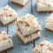 Creamy Coconut Cheesecake Bars topped with toasted coconut and almonds, a delicious Low Calorie Coconut Dessert perfect for healthy snacking or light dessert cravings.