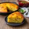 A warm skillet of Corn Bread Recipe baked to golden perfection, packed with cheese and peppers, inspired by Southern Recipes and classic Cajun Cornbread from authentic Southern Cooking traditions.