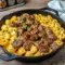 Juicy Cajun steak bites and creamy pasta shells in a skillet, a rich and comforting Date Night Dinner Ideas favorite featuring Cheesy Garlic Steak Bites and an easy one-pan Steak Skillet Recipes meal perfect for a romantic dinner.