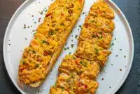 Ultimate Crawfish Bread Recipe With Cream Cheese for Serious Flavor Lovers1 This Crawfish Bread Recipe features crusty French bread filled with cheesy crawfish, Cajun seasoning, and butter, baked until gooey and golden for an easy Crawfish Bread Recipe Easy appetizer packed with Southern flavor.
