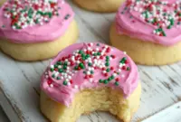 Addictive Keto Sugar Cookies Almond Flour With Dreamy Frosting2 A stack of soft Keto Sugar Cookies Almond Flour topped with creamy pink Keto Cookie Frosting, showing thick, pillowy Low Carb Sugar Cookies with smooth, spreadable Keto Icing For Cookies on top.