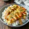 Hearty skillet of smothered chicken served over fluffy rice, showcasing Perfect Winter Meals comfort and creamy Comfort Food With Gravy goodness.