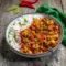 A hearty bowl of Creole Recipes Louisiana–inspired Couvillion Recipe, showcasing classic Creole Cooking with fish and crawfish simmered in a deep, flavorful Creole courtbouillon sauce.
