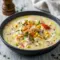 A warm bowl of Crab & Corn Chowder made with sweet corn, tender crab meat, and a creamy broth, garnished with fresh herbs for a comforting seafood dinner.