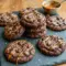 Sea Salt Caramel Cookies stacked with gooey centers, chocolate chunks, and caramel swirls, topped with flaky sea salt for a decadent Salted Caramel Cookies Recipe dessert experience.