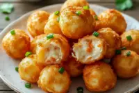 Golden fried crab rangoon bombs plated hot and crisp — this Seafood Delight Recipe showcases creamy seafood centers inside crunchy wrappers, perfect Appetizer Snacks for sharing.