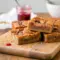 Close-up of thick, chewy blondie bars swirled with jam and peanut butter, showcasing a marbled top and dense texture—an indulgent Peanut Butter And Jelly Dessert that looks like homemade Pb And J Blondies fresh from the pan.