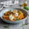 Bowl of silky Red Pepper Pasta topped with burrata and herbs, styled as rich Savoury Food perfect for cozy homemade Pasta Dishes.
