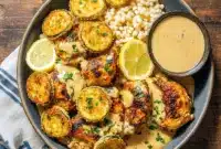 Fresh Healthy Dinner - Creamy Lemon Butter Chicken with Crispy Zucchini Delight1 This Healthy Creamy Dinner features golden lemon butter chicken topped with creamy sauce, served alongside crispy mozzarella zucchini rounds and fluffy couscous for a vibrant One Dish Healthy Meal.