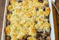 Must-Try Stuffed Mushrooms Casserole — Cheesy Comfort Bliss1 Freshly baked Stuffed Mushrooms Casserole with a golden breadcrumb crust, served hot as a creamy Cheesy Mushroom Casserole Dish in a rustic baking pan.
