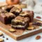 Close-up of Bourbon Cream Cheese Brownies featuring a glossy chocolate base and creamy bourbon swirl baked into thick, fudgy squares that look rich, decadent, and bakery-worthy.