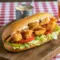 Shrimp Poboys Recipe featuring a crispy Fried Shrimp Sandwich stacked on French bread with lettuce, tomatoes, pickles, and rich Creole Sauce For Po Boy, inspired by iconic New Orleans flavors.