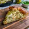Golden baked Dill Pickle Pizza With Ranch Sauce topped with melted mozzarella, creamy Dill Pickle Pizza Sauce, and tangy dill pickle slices on a crispy crust, a bold and flavorful Pickle Ranch Pizza perfect for pickle lovers.