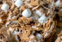 Delicious bars of Golden Graham S'mores Dessert loaded with melted marshmallows, chocolate chips, and crunchy cereal — a fun S'mores Recipe With Golden Grahams that works perfectly as a Tailgate Dessert Idea or quick party sweet.