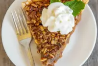 Layered Pecan Pumpkin Pie With Crunchy Pecan Topping1 Slice of Layered Pecan Pumpkin Pie showing distinct pumpkin base and glossy Pumpkin Pie Pecan Topping with chopped pecans, a festive Homemade Pecan Pumpkin Pie ready for a holiday table.