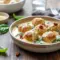 Creamy skillet of Chicken Ricotta Meatballs served with rich sauce, featuring Baked Chicken Ricotta Meatballs With Spinach Alfredo Sauce for a cozy dinner.