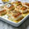 A close-up of Baked Cod Coconut Lemon in a rich, creamy sauce with herbs and peppers—perfect Baked Cod In Coconut Lemon Cream Sauce for a flavorful dinner.