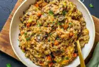 Golden, creamy Chicken Wild Rice Casserole baked in a casserole dish with tender chicken, wild rice, and herbs—perfect for a cozy Wild Rice Casserole Dinner inspired by classic Wild Rice Recipes Casseroles.