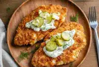 Dill Pickle Chicken Parmesan — Tangy Twist on a Classic Dinner1 Dill Pickle Chicken Parmesan topped with a golden breadcrumb crust, fresh dill, and creamy pickle sauce—an easy Crispy Dill Parmesan Chicken made in the air fryer.