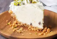 Italian Cannoli Cream Pie — Rich, Creamy & Irresistible1 Slice of Italian Cannoli Cream Pie topped with whipped cream, pistachios, and mini chocolate chips, inspired by Italian Recipes Authentic Desserts and styled like a No Bake Cannoli Cream Pie with a crisp crust and creamy filling.