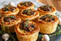 Golden-brown Mini Pot Pies baked in ramekins with flaky Puff Pastry Pie Crust, filled with creamy mushroom and Gruyère, styled as elegant Savory Mini Pies for a cozy dinner or Dinner Party Entree.