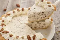 Pecan Cream Pie — Rich, Creamy & Irresistible1 Pecan Cream Pie topped with chopped pecans and swirls of whipped cream in a classic pie dish, showcasing a thick and fluffy Pecan Cream filling—perfect for Thanksgiving Cream Pie celebrations and elegant Creme Pies dessert tables.