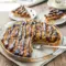 Slice of Samoas Cookie Pie topped with toasted coconut, caramel drizzle, and melted chocolate, inspired by Samoas Cookies Recipe and classic Girl Scout Cookie Recipes, served as a rich and gooey Samoa Pie dessert.