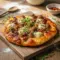 Freshly baked Sausage Ricotta Honey Hot Pizza topped with creamy cheese, sausage, and herbs—perfect for Rustic Pizza Recipes lovers.