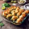 Golden baked Spinach and Artichoke Stuffed Shrimp topped with creamy filling, inspired by a rich Shrimp Rockefeller Recipe and perfect for elegant seafood dinners.