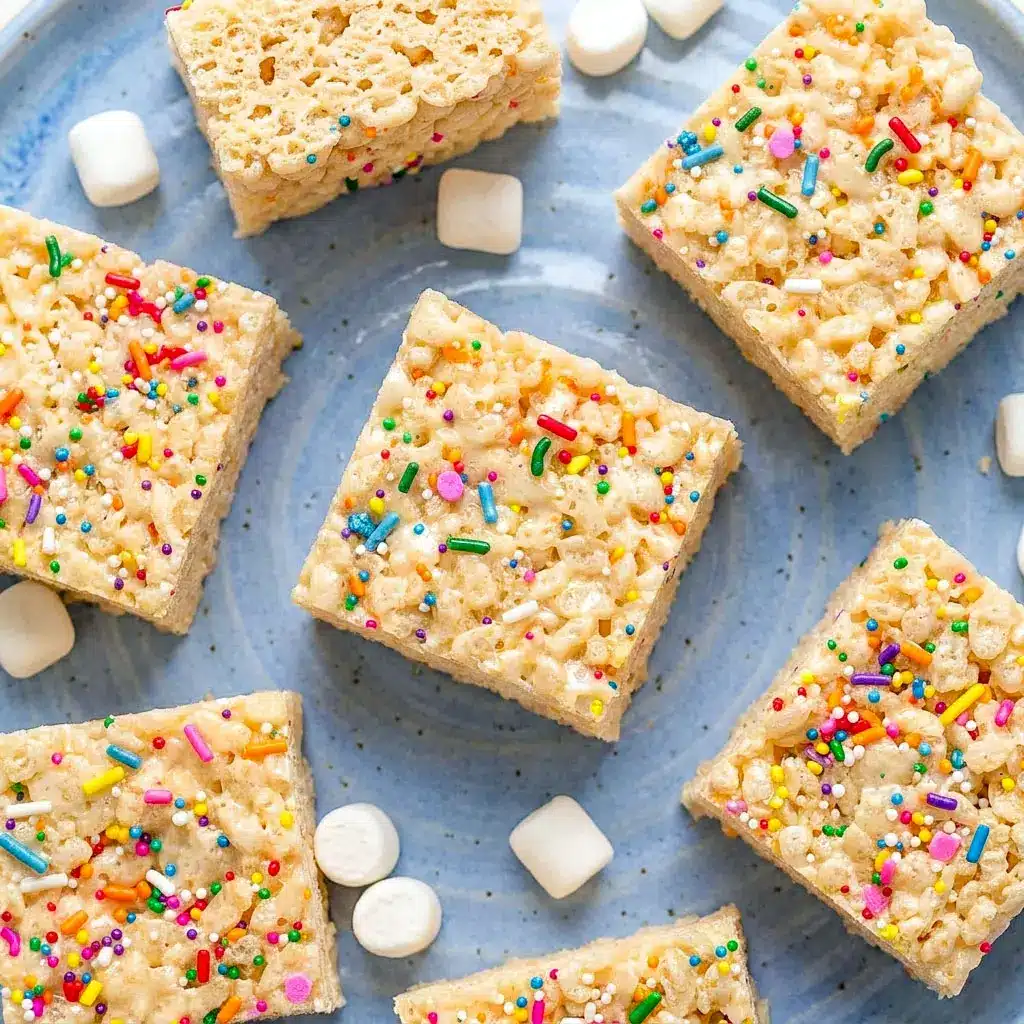 Soft and gooey Protein Rice Krispies stacked on a plate with melted marshmallows and colorful sprinkles, perfect for easy Low Calorie Protein Rice Crispy Treats and homemade Rice Krispie Protein Bar ideas.