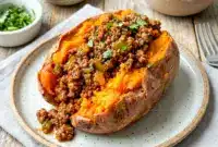 Loaded Sloppy Joe Sweet Potatoes topped with savory ground beef sauce and fresh herbs for an easy healthy dinner. These cozy Whole30 Sloppy Joes and Paleo Sweet Potato Sloppy Joes make the perfect comfort food meal prep idea.