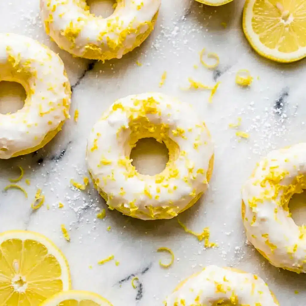 Soft and citrusy Lemon Vanilla Protein Donuts with Glaze topped with creamy icing, perfect for a High Protein Donut Recipe and healthy Glazed Protein Donuts breakfast treat.