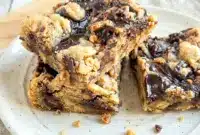 Freshly baked Moose Tracks Cookie Bars loaded with fudge swirls and peanut butter cups, a perfect Dessert With Reeses Cups and one of the most delicious Fun Unique Desserts.