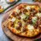 Sausage Ricotta Honey Hot Pizza on a wooden board with melted cheese and a sweet-spicy finish, one of the Best Pizza Ideas for cozy dinners and easy entertaining.