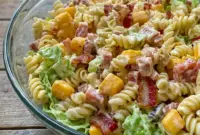 Club Sandwich Pasta Salad served as a colorful Turkey Club Pasta Salad with pasta, turkey, ham, bacon, cheese, lettuce, and tomatoes.