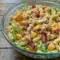 Club Sandwich Pasta Salad served as a colorful Turkey Club Pasta Salad with pasta, turkey, ham, bacon, cheese, lettuce, and tomatoes.
