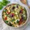 A bright bowl of Sundried Tomato Feta Orzo Salad with herbs and olives, perfect for Mediterranean Orzo Pasta Salad Recipes that taste fresh and satisfying.