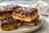 Easy Turtle Bars 4 Ingredients Cookie Bars for a Family Picnic Easy Turtle Bars on a dessert tray with gooey caramel and chocolate, perfect for Coconut Chocolate Bars lovers.
