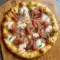 A golden White Pizza with Prosciutto & Hot Honey topped with creamy cheese and crisp prosciutto, perfect for a homemade Specialty Pizza night.