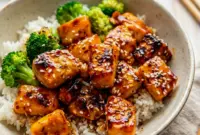 Glazed in a sticky citrus sauce, these Crispy Orange Salmon Bowls are one of the best Orange Dinner Recipes for a quick weeknight meal.