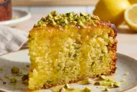 Topped with crunchy nuts and a glossy glaze, this Flourless Lemon Pistachio Cake is a stunning example of Olive Oil Cake Almond Flour baking.